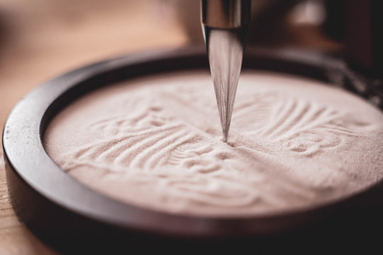 Sand Pendulum Creating Pattern In Wooden Bowl (selective Focus)