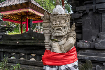 Traditional Balinese demon statue dressed for a traditional festival
