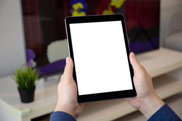 man hands holding computer tablet with isolated screen in room