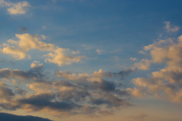 Landscape with dramatic light - beautiful golden sunset with saturated sky and clouds.