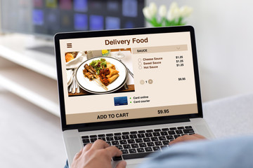 male hands on keyboard laptop with app delivery food