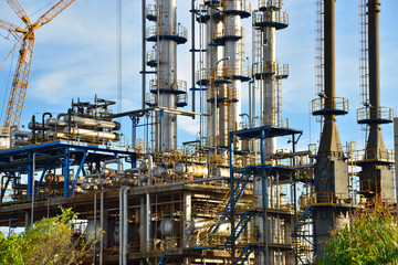 Close-up of pipelines and destillation tanks of an oil-refinery plant