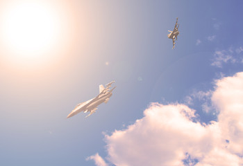 Two fighters in the blue sky. Sunset.