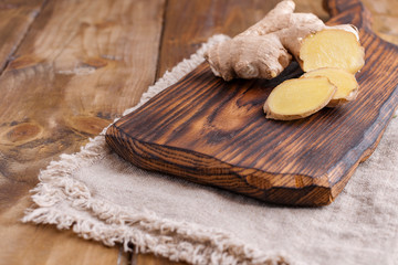 Ginger and lemon on a wooden background, Photo in a rustic style. Ingredients for warming and health drink. Alternative medicine. Free space for text