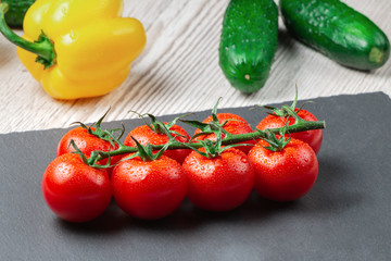 Tomatoes on a branch close-up top view.