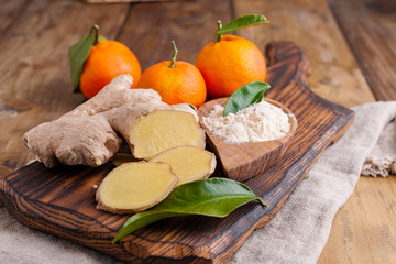 Ginger and lemon on a wooden background, Photo in a rustic style. Ingredients for warming and health drink. Alternative medicine. Free space for text