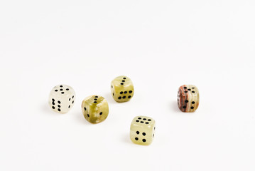 Dices made of natural stone on a white background. Copy space. Gaming.