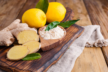 Ginger and lemon on a wooden background, Photo in a rustic style. Ingredients for warming and health drink. Alternative medicine. Free space for text