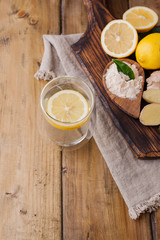 ginger, lemon and glass on a wooden background, Photo in rustic style. Ingredients for warming and health drink. Alternative medicine. Free space for text