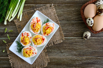 Fototapeta na wymiar Deviled eggs. Delicious appetizer. Boiled eggs stuffed with yolk, mustard, mayonnaise, paprika. Classic recipe. The top view