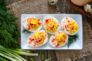 Deviled eggs. Delicious appetizer. Boiled eggs stuffed with yolk, mustard, mayonnaise, paprika. Classic recipe. The top view