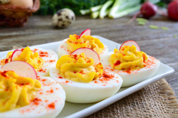 Deviled eggs. Delicious appetizer. Boiled eggs stuffed with yolk, mustard, mayonnaise, paprika. Classic recipe.