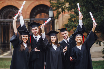 Group of students attending graduation ceremony. Nice day!