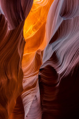 The golden orange light gives off a magical glow on the canyon walls on a southern Utah slot canyon geological area Between Page AZ and Kanab UT.  the slot canyons of Arizona Desert are amazing - obrazy, fototapety, plakaty