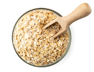 Oatmeal in a plate with a wooden shovel on a white. The form of the top.