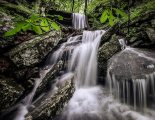 A lost waterfall found deep in the national Ozark forest of Arkansas. This scenic cascade of falling water is found deep in the Ozark mountains near Jasper, Ponca and Boxley valley AR.  