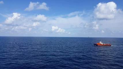 Songkhla, Thailand-February 18, 2019 : Red Supply boat transfer cargo to oil and gas industry and moving cargo from the boat to the platform. Boat is waiting transfer cargo and crews to platform.