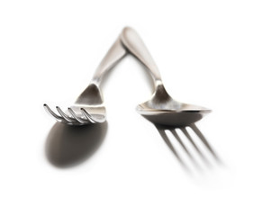 Cutlery on white background, the misunderstanding of the shadows, conceptual 