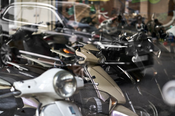 Fototapeta na wymiar Motorbike store with panoramic windows with traffic reflection