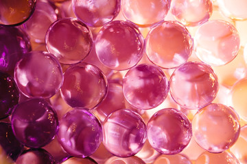 Abstract background with shiny water balls in violet and orange colors