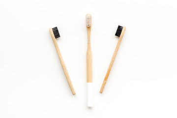 bamboo dental cleaning brush for zero waste lifestyle concept on white background top view