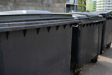 Black plastic trash containers for separate collection and sorting of garbage for environmental protection