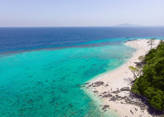 Obraz na płótnie Canvas Aerial view of the beach on an island in the blue ocean