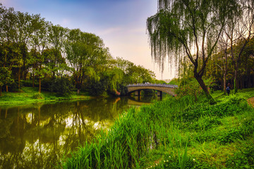 Old traditional Chinese bridge in city park.