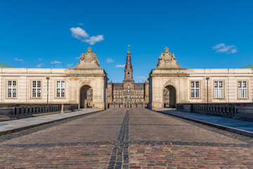 Fototapeta premium Entrance of Christiansborg Palace under a blue sky on a sunny day