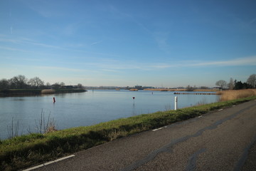 Blue sky and sun over the River Hollandsche IJssel at Moordrecht in the Netherlands