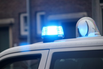 Blue flashinglight of a police car in the streets of Nieuwerkerk aan den Ijssel in the Netherlands