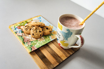 Cookies and smoothie drink on white table,porcelain cup