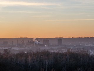 steel factory near a town close to the woods