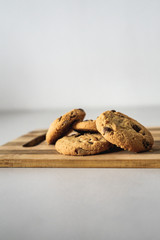 Cookies on wood plate on white table and background