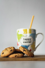 Cookies and smoothie drink on white table, porcelain cup