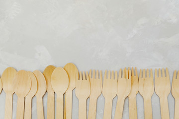 Wooden tableware on neutral background. Zero waste concept, top view. Image with copy space.