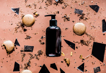 spilled chocolate from bottle and macarons and crumbs