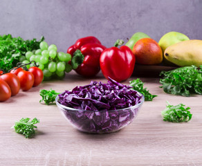 fresh red cabbage salad with vegetables in the background
