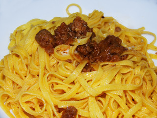 Tagliatelle al ragù, italian food, on white background