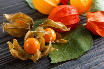 juicy winter cherry on a wooden rustic background