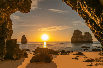 Beautiful beach photographed from a cave at sunrise