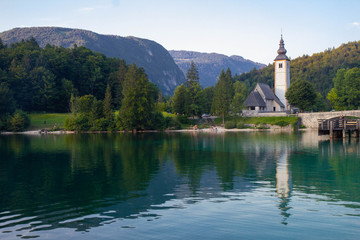 Bohinj Lake, Church of St John the Baptist with bridge. Triglav National Park, Julian Alps, Slovenia