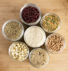 Top view of jars with an assortment of rice, beans and legumes