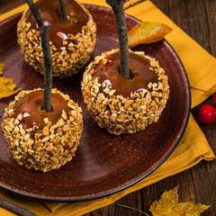 Caramel Apples on Wooden Background. Selective focus.