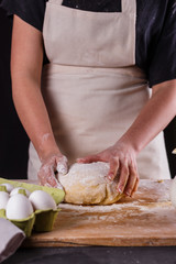 young woman wearing a duck on a wooden board in an apron