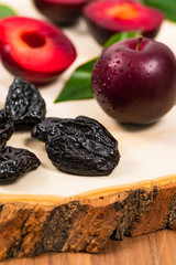 Dried Plums Pitted Prunes and Fresh Plums. Selective focus.