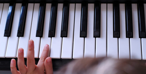 toddler having fun playing piano