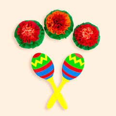 Symbols of Cinco de Mayo maracas and mexican flowers