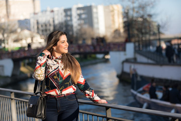Beautiful brunette young woman in jeans and shirt.