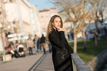 Fototapeta premium Beautiful girl listening to the music with earphones